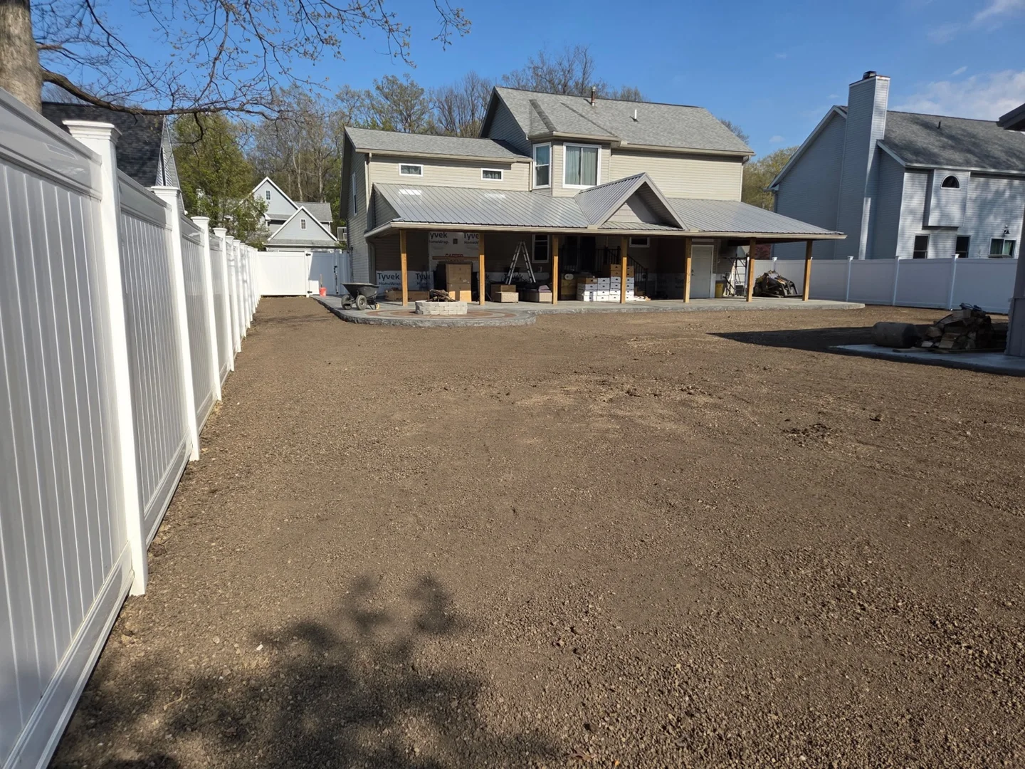 Backyard soil graded near the patio